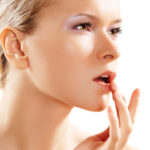 Health & skin care. Lovely woman touching her lips ABC pielęgnacji ust